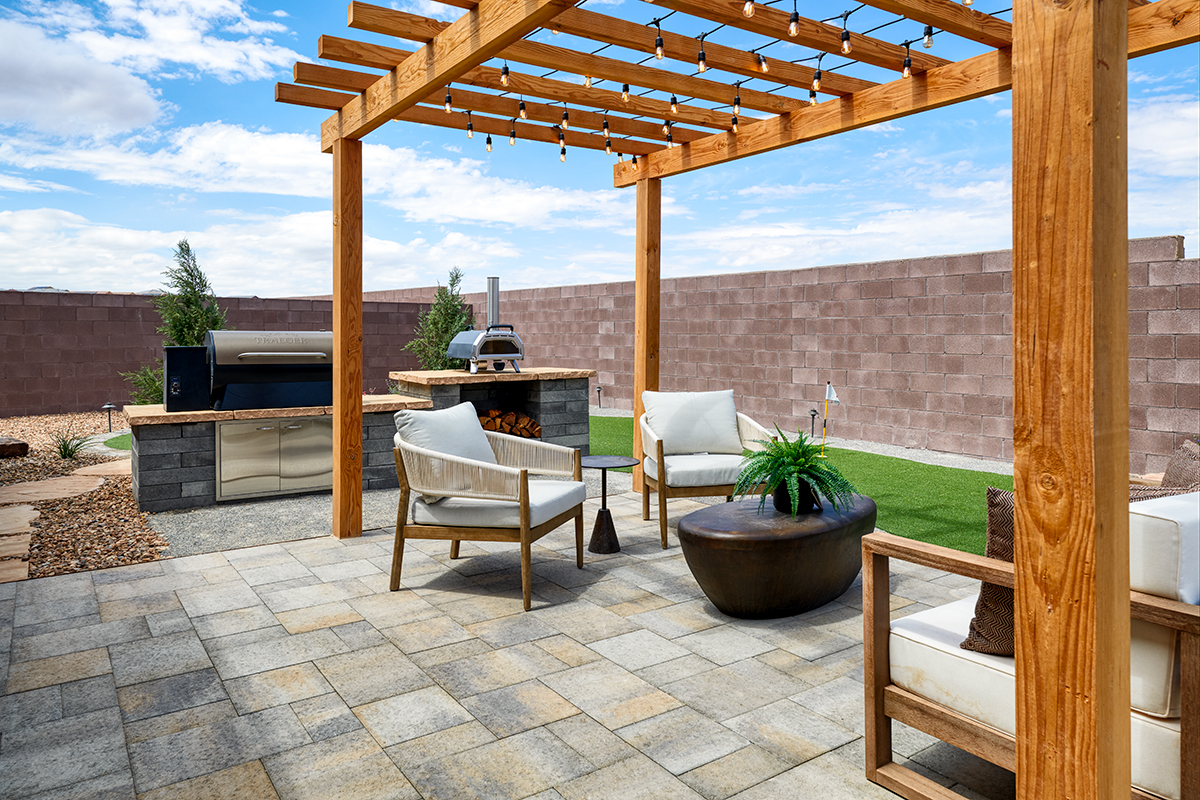 Pergola with sitting area and nearby grill