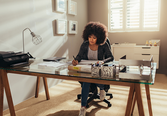 Homebuyer at a desk, researching closing costs