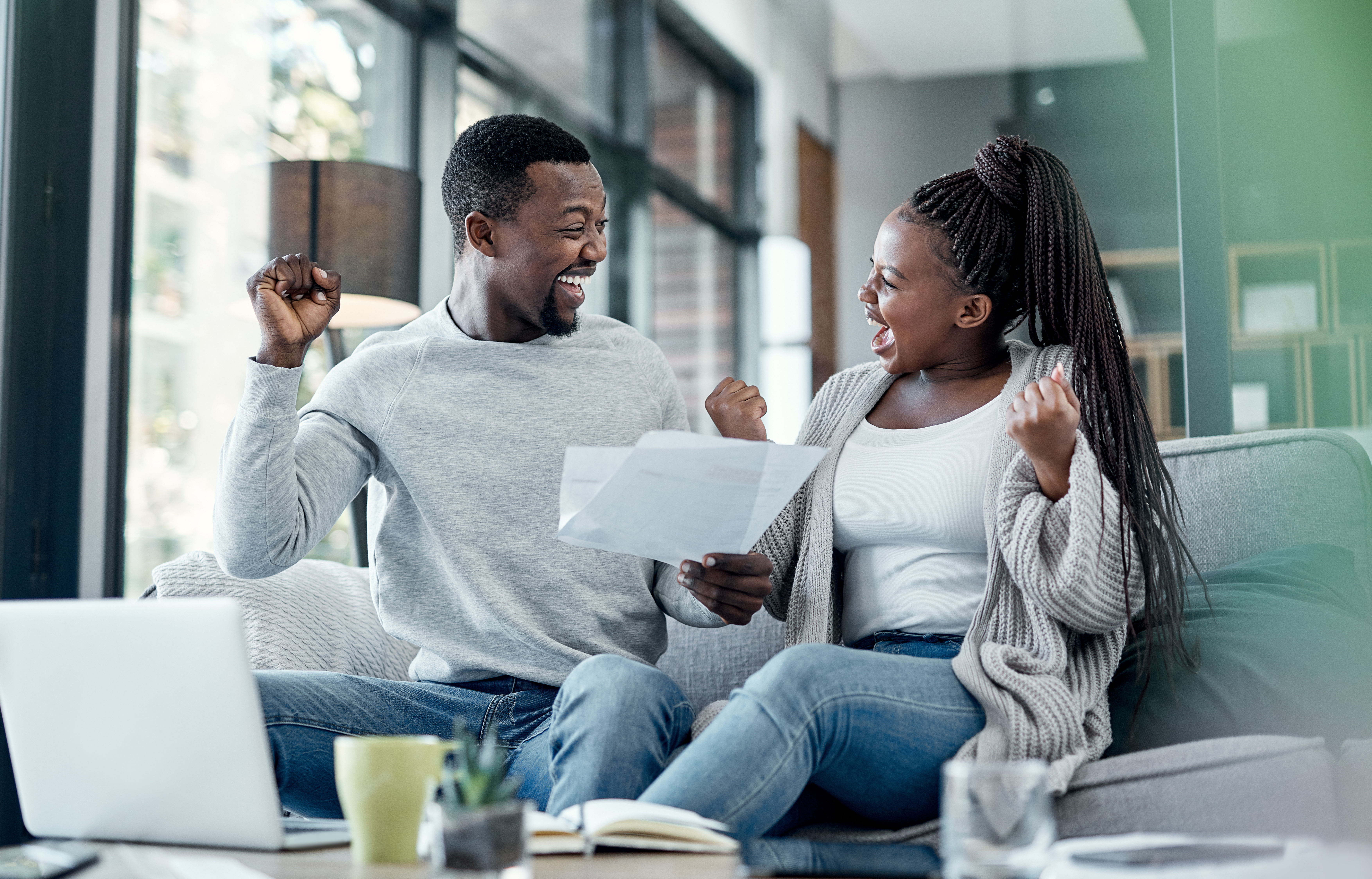 Young couple celebrating their new debt free status