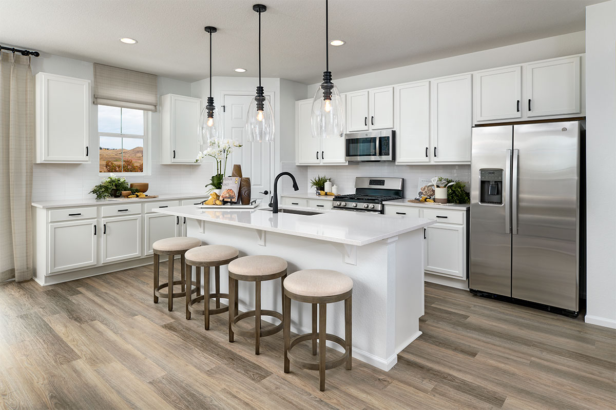 Clean kitchen with white cabinets and countertops, stainless-steel appliances and a kitchen island.