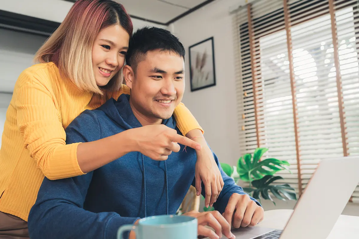 Man and woman home shopping on computer