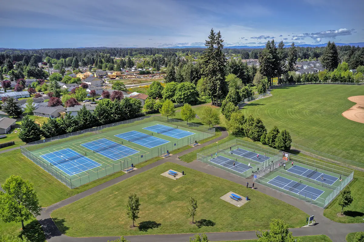 Aerial view of community tennis courts, park space, and picnic tables